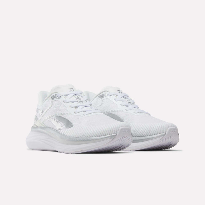 A pair of Reebok Women’s Viva Speed Shoes in white with subtle gray accents, featuring breathable mesh uppers and thick, extra-cushioned soles, displayed against a plain white background.