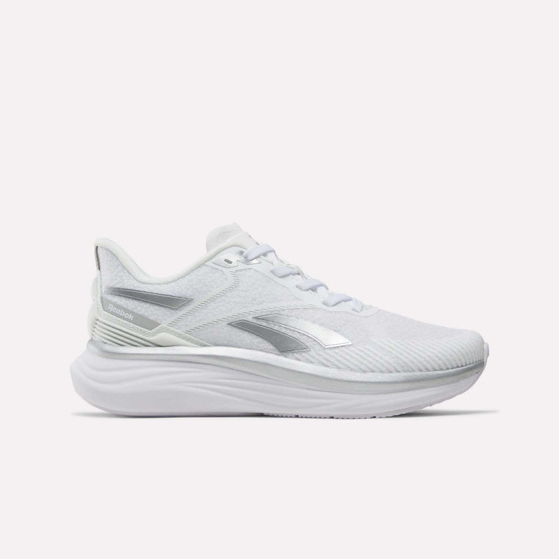 Side view of the Reebok Women’s Viva Speed Shoes in white with silver accents, featuring a mesh upper, white laces, and a thick, extra-cushioned sole against a plain light background.