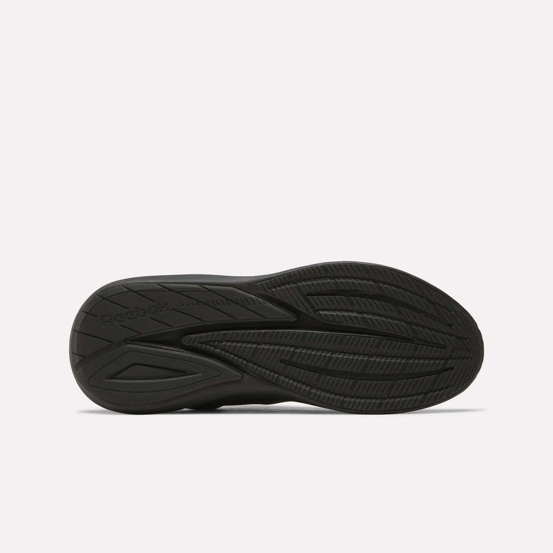 The image displays the black rubber outsole of Men's Viva Speed Shoes by Reebok, highlighting textured grooves and patterns for traction, set against a plain white background.