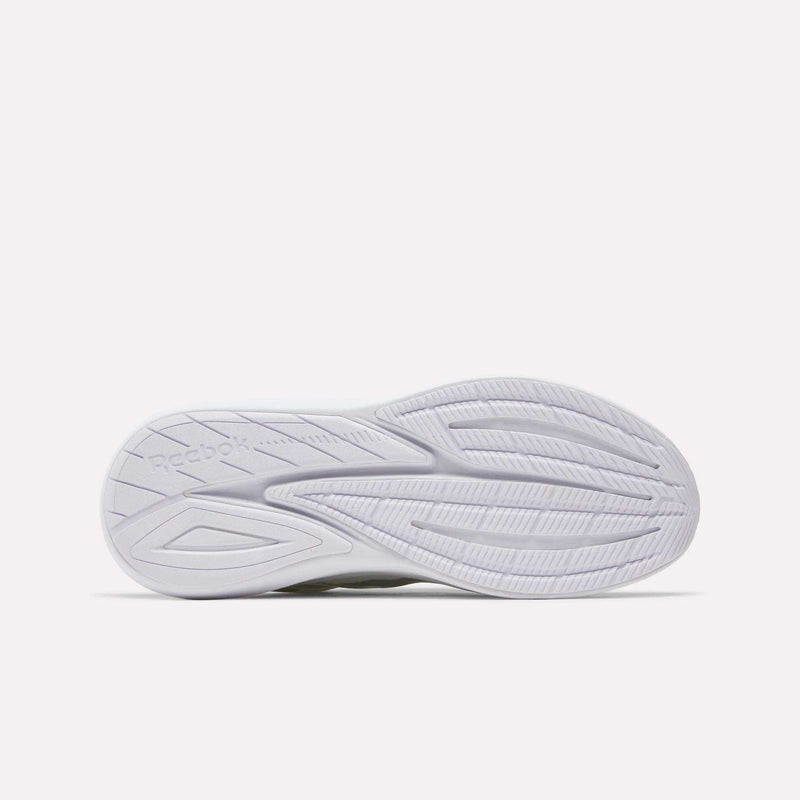 The image shows the bottom view of a white Reebok Men's Viva Speed shoe sole, featuring textured lines and grooves for traction, with the Reebok logo embossed on the left side. Part of Reebok's cushioned running shoes collection, these breathable Men's Viva Speed Shoes deliver comfort and support for everyday wear.