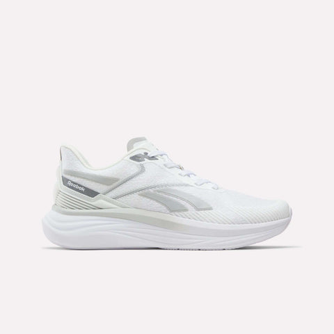 A white Men's Viva Speed Shoe by Reebok, featuring a breathable mesh upper, subtle gray logo accents, and a thick cushioned sole for all-day comfort—shown against a plain white background.
