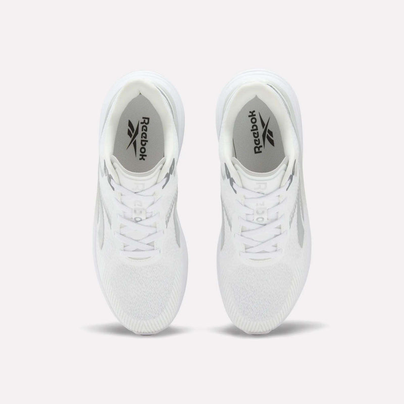 A pair of Men’s Viva Speed Shoes by Reebok in white is displayed from above on a light background, highlighting the Reebok logo on the insoles and the mesh uppers for enhanced breathability.