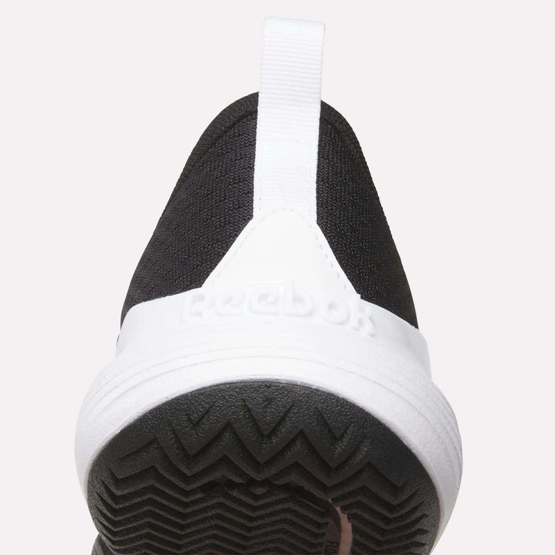 Close-up of the heel of a black Men’s Phase Advantage Tennis Shoe by Reebok, featuring a white midsole and a textured black rubber outsole.