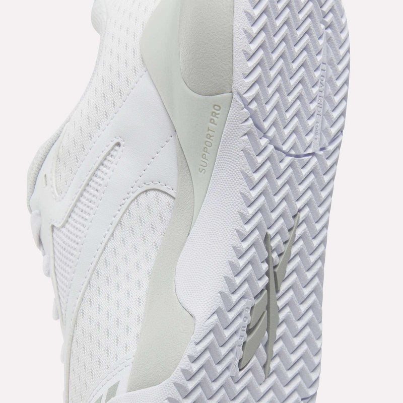 Close-up of a white Men’s Phase Advantage Tennis Shoe by Reebok, highlighting the textured herringbone tread on the sole and a Floatride EVA midsole marked with the text SUPPORT PRO.