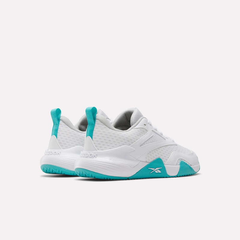 Women’s Phase Advantage tennis shoes in white with teal heel tabs and teal patterned rubber outsoles.