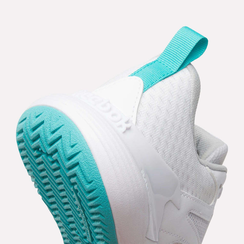 Close-up of the heel of a white Reebok Women’s Phase Advantage Tennis Shoe featuring a bright teal pull tab and a matching teal treaded sole.