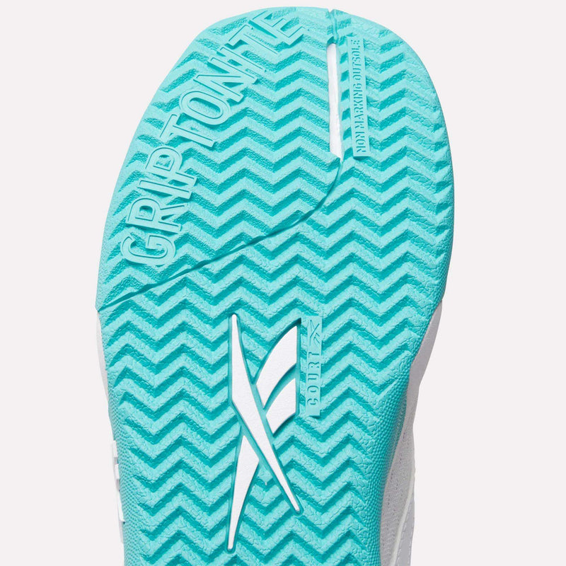 Close-up of a bright blue Women’s Phase Advantage tennis shoe sole featuring a chevron tread pattern and the embossed text GRIPTONITE and NON MARKING OUTSOLE.