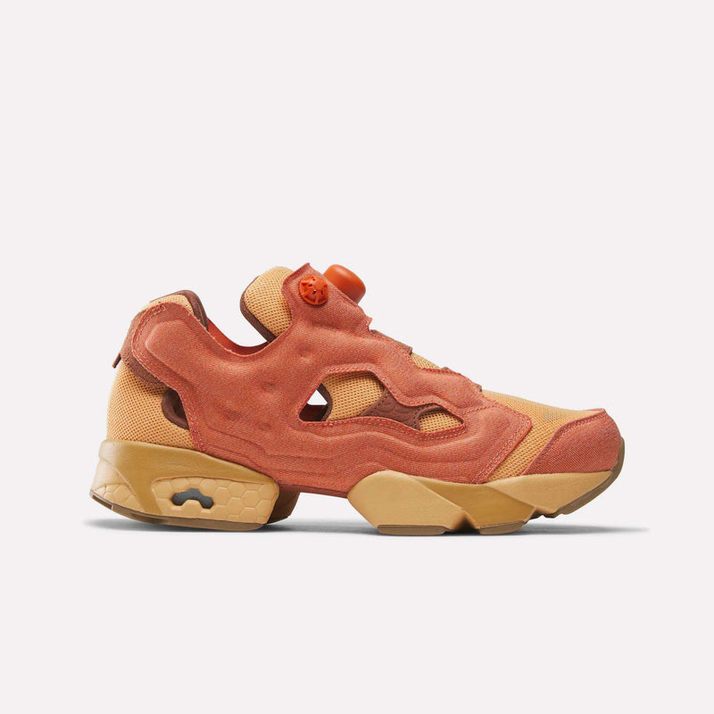 Reebok x Avatar Instapump Fury 94 shoes in orange and tan, featuring an inflatable pump mechanism on the tongue and a chunky sole.