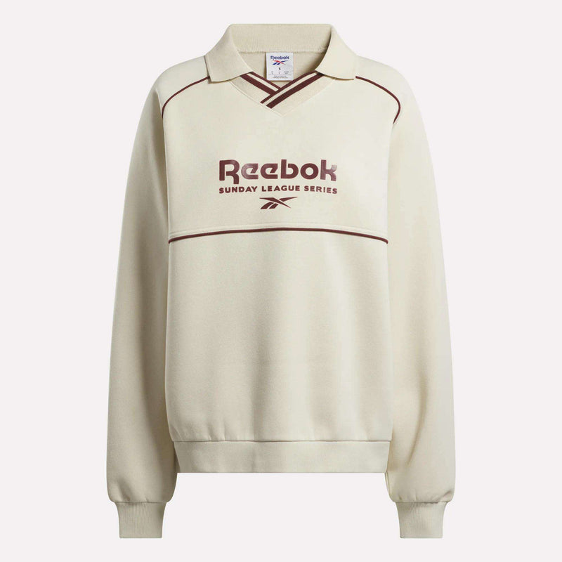 The Reebok Women's Heritage Crewneck Sweatshirt features a cream brushback fleece, collar, maroon piping, Sunday League Series text and logo on the front, plus long sleeves with ribbed cuffs and hem.