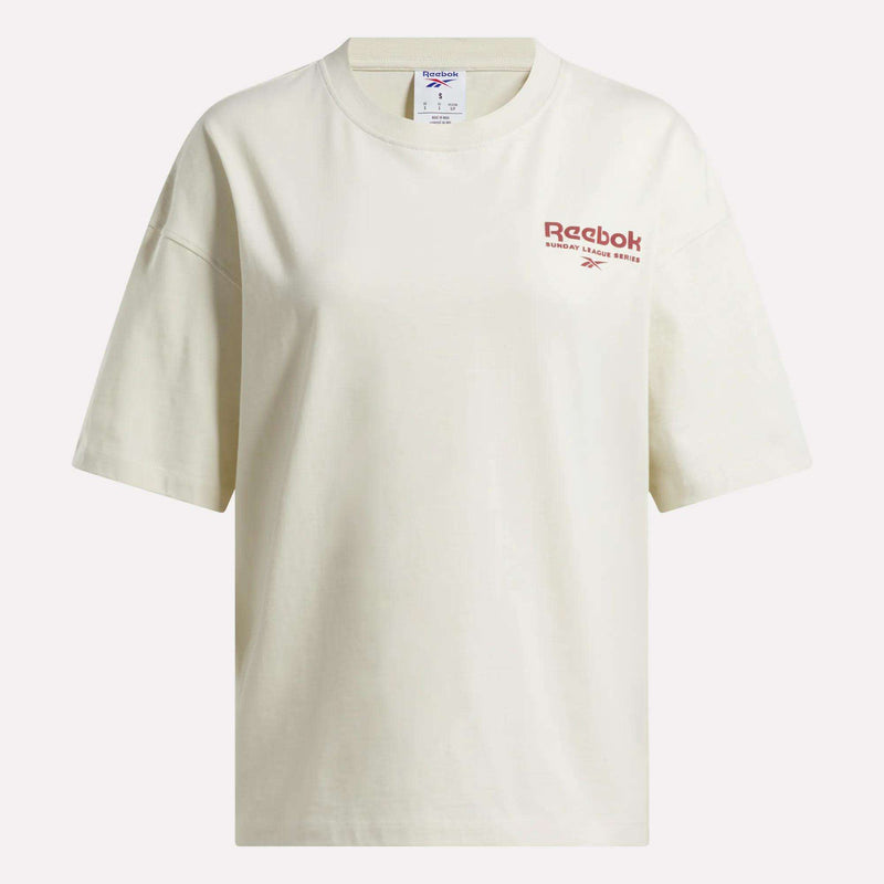 The Reebok Women's League Club Graphic T-Shirt is an off-white cotton tee with a relaxed fit, featuring the red Reebok logo and text on the left chest.