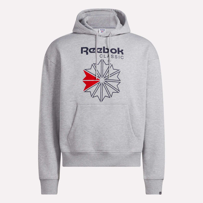 The Men’s Starcrest Relaxed Hoodie by Reebok is a light gray fleece hoodie featuring a spacious front pocket, adjustable drawstring hood, and a striking blue and red geometric Starcrest logo beneath the Reebok Classic text on the chest. Combining comfort with timeless style, this men’s hoodie is crafted for relaxed everyday wear.