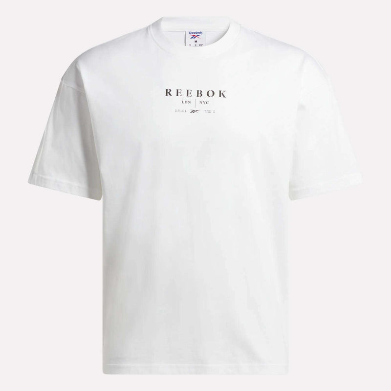 The Reebok Men's International T-Shirt is a versatile, short-sleeve tee crafted from soft cotton jersey in plain white, featuring bold black "REEBOK LDN NYC" lettering on the front—ideal for casual wear.
