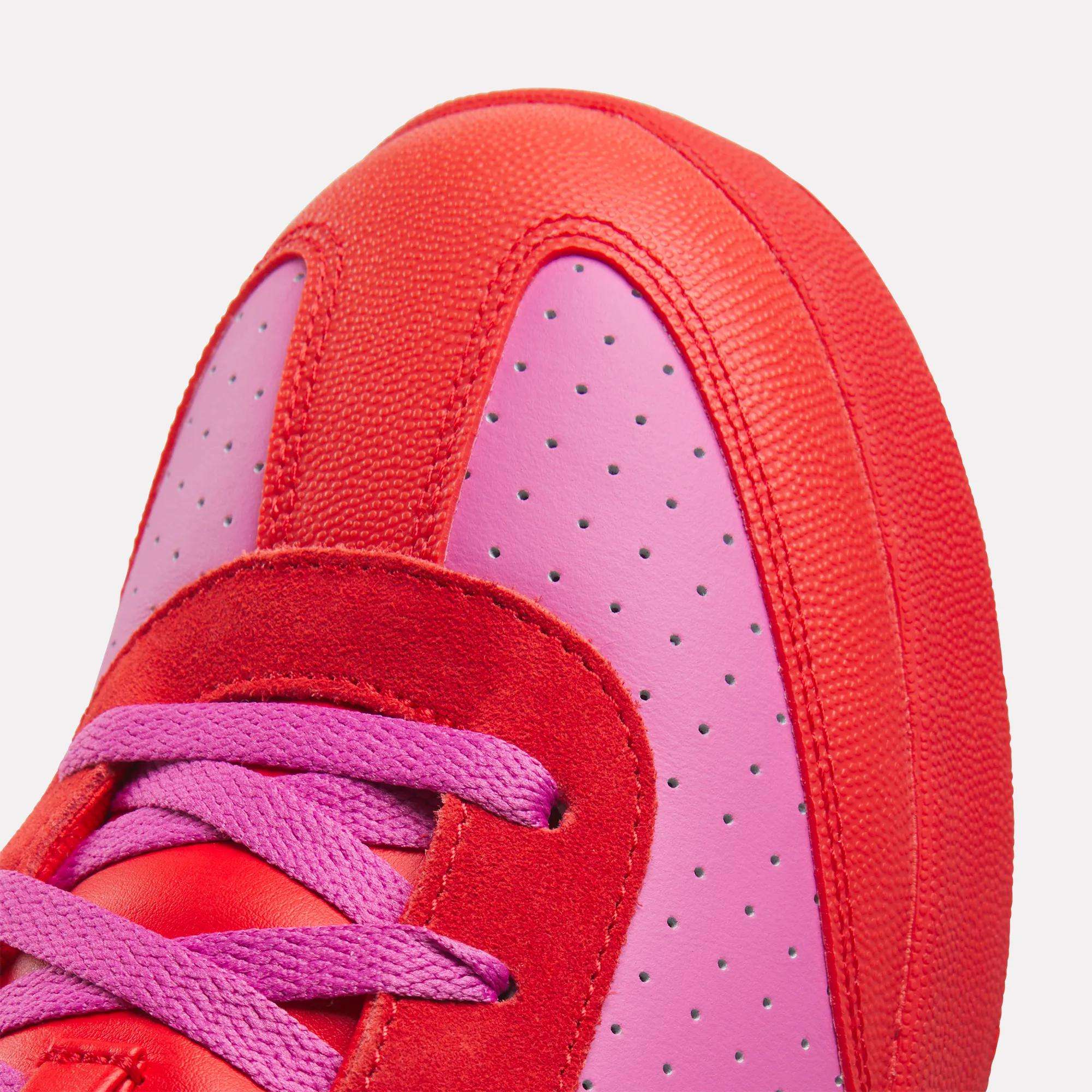 Close-up of the Reebok x BBC Board Flip Skate Shoes, featuring a bold red and pink colorway with pink laces, perforated pink leather, and red suede and fabric accents—ideal for standout street style.