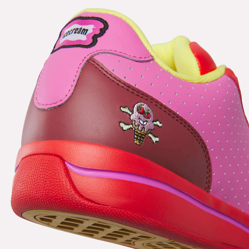 Close-up of the heel of Reebok x BBC Board Flip Skate Shoes, featuring colorful pink, red, and yellow accents with an embroidered melting ice cream cone and an "icecream" patch on the heel tab—showcasing bold street style.