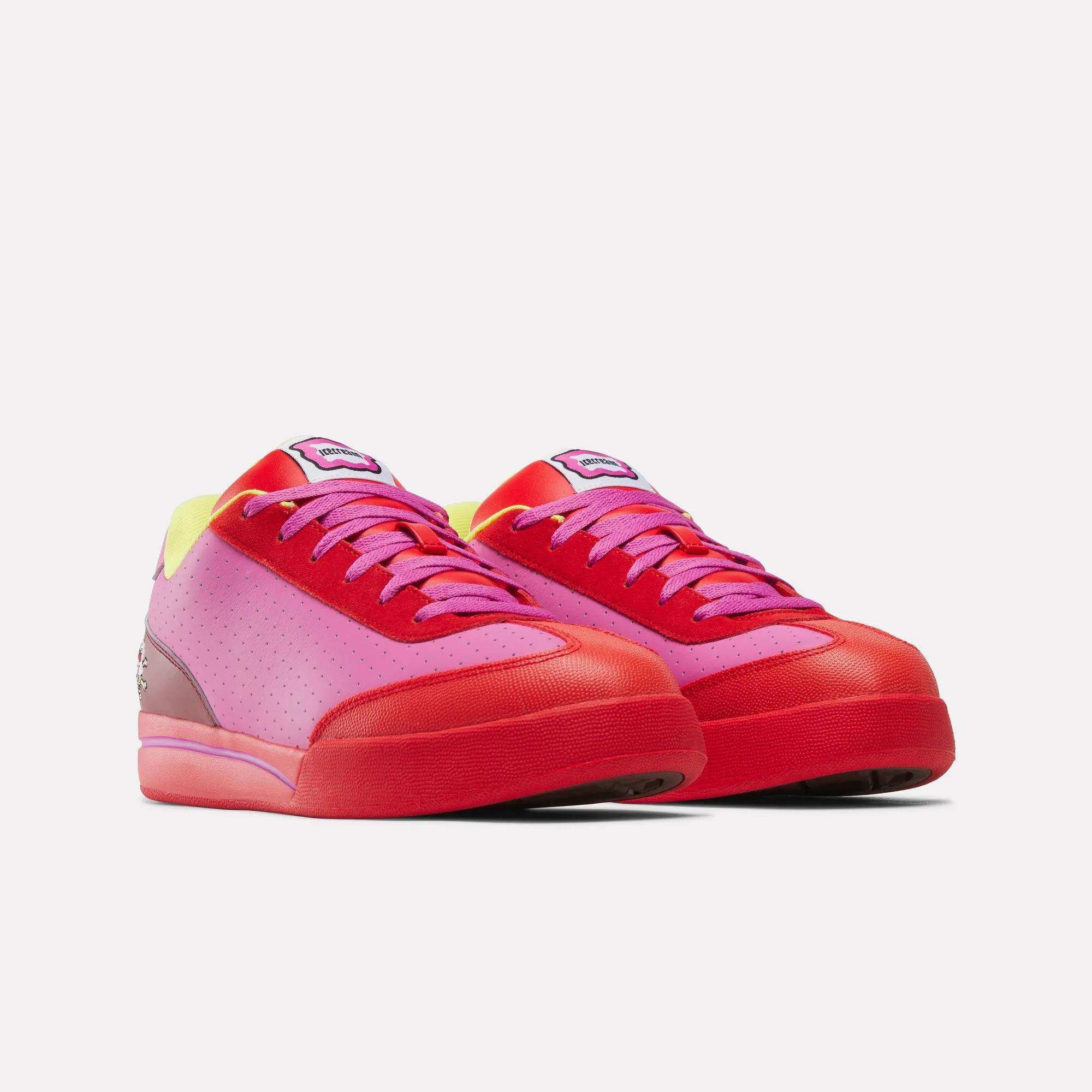 The Reebok x BBC Board Flip Skate Shoes by Reebok feature a low-top gradient design with pink sides, red toes and soles, yellow ankle accents, and purple laces—perfect for street style and displayed against a white background.