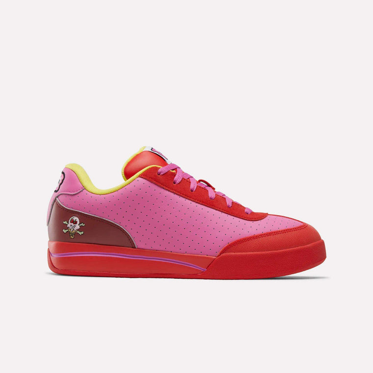 The Reebok x BBC Board Flip Skate Shoes feature a pink upper, red toe and sole, yellow lining, red laces, and a small skull and crossbones graphic for standout street style.