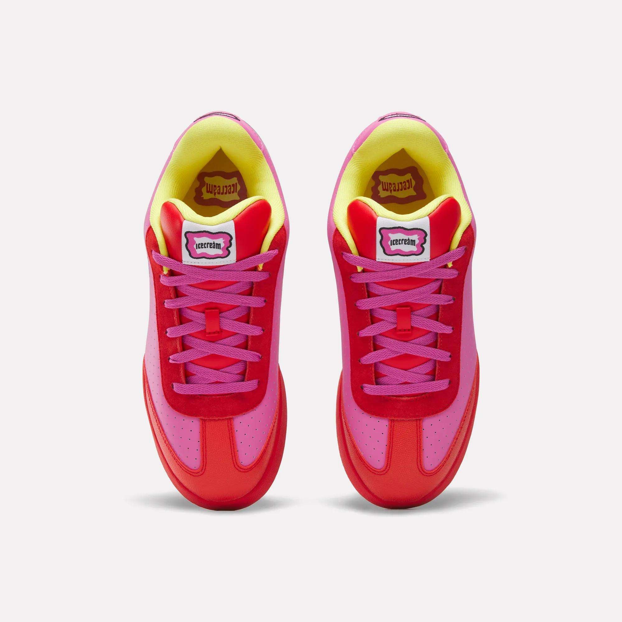 Top view of Reebok x BBC Board Flip Skate Shoes featuring vivid red, pink, and yellow accents, pink laces, and a white "TERRITORY" label on each tongue—perfect for street style against a white background.
