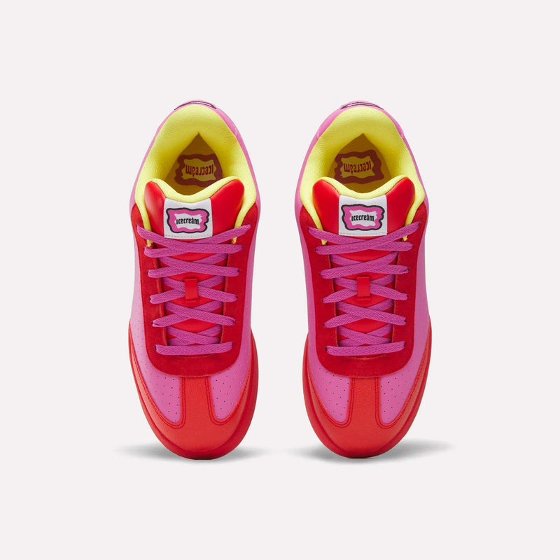 Top view of Reebok x BBC Board Flip Skate Shoes featuring vivid red, pink, and yellow accents, pink laces, and a white "TERRITORY" label on each tongue—perfect for street style against a white background.
