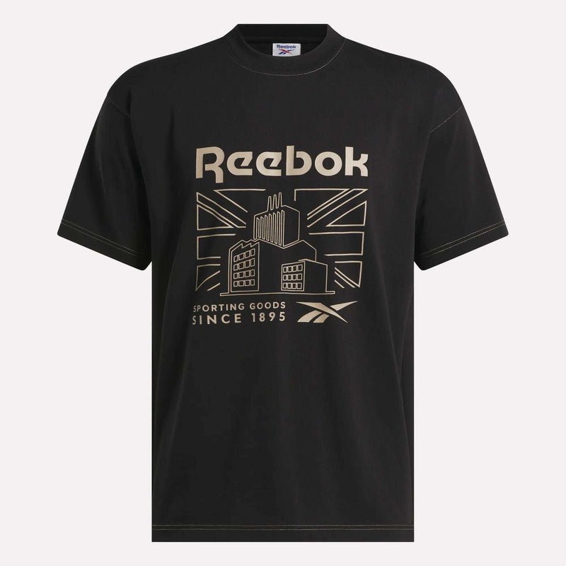 The Reebok Men's Big Graphic T-Shirt is a comfortable black cotton jersey tee featuring a bold gold building graphic, a stylized Union Jack flag, and "Reebok Sporting Goods Since 1895" text. Its classic crewneck design offers timeless style.