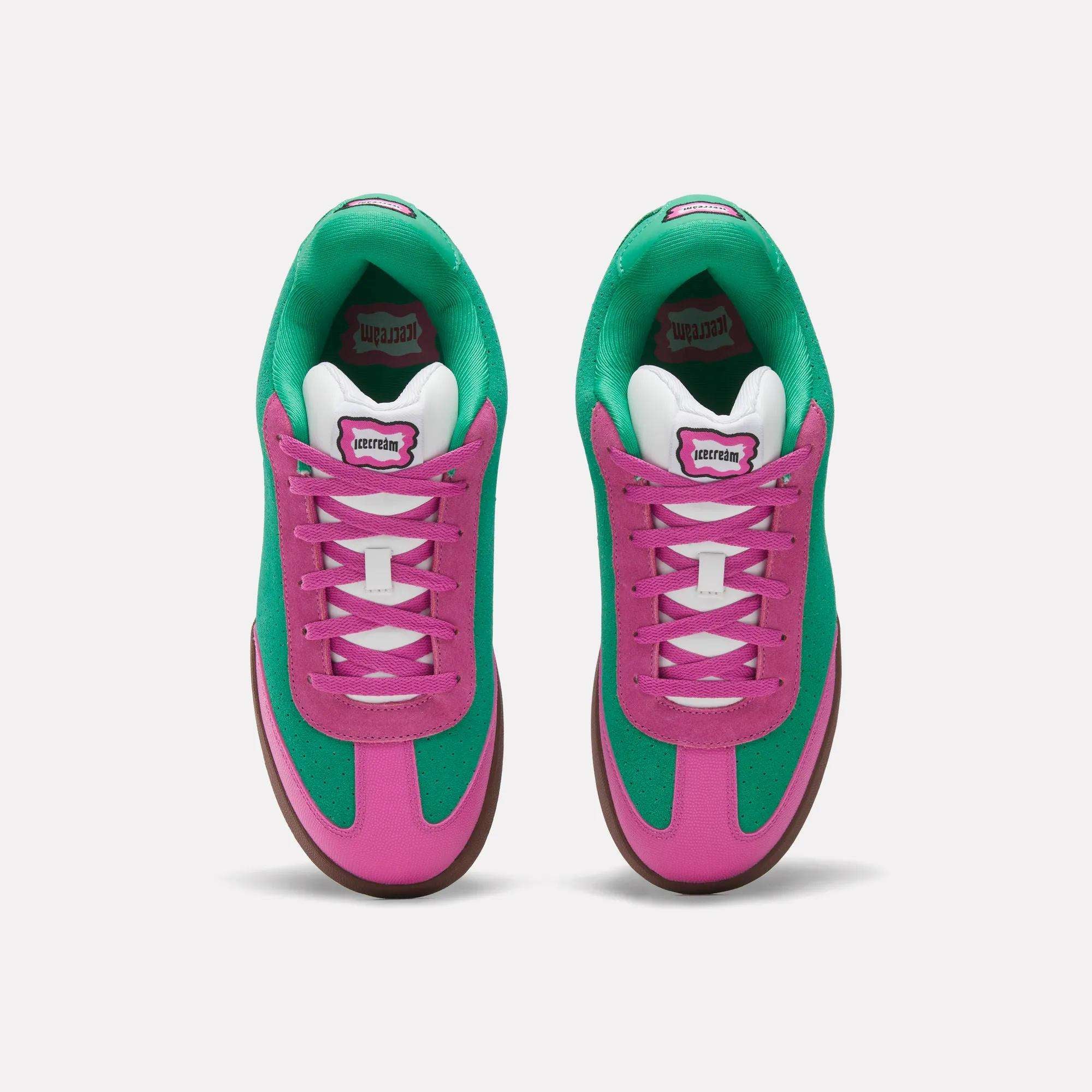 Top view of Reebok x BBC Board Flip Skate Shoes with bright green suede sides, vibrant pink overlays, white laces, and gum-colored outsoles on a plain white background.