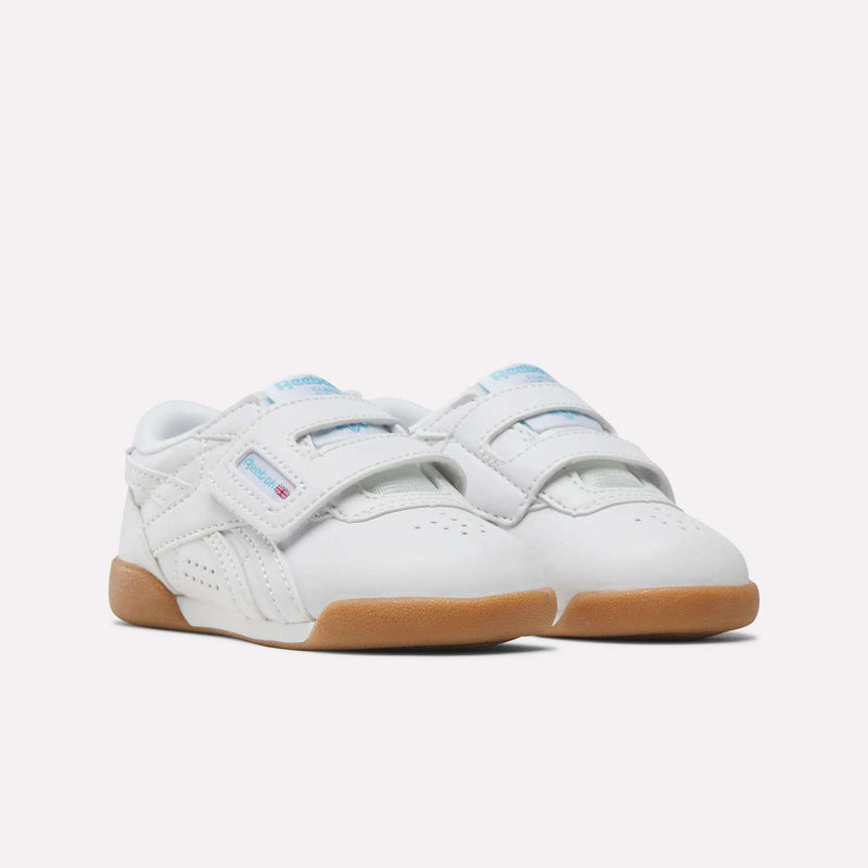 White Reebok Freestyle Lo Shoes - Baby & Toddler infant sneakers featuring ’80s aerobics style with dual hook-and-loop straps and gum rubber soles.