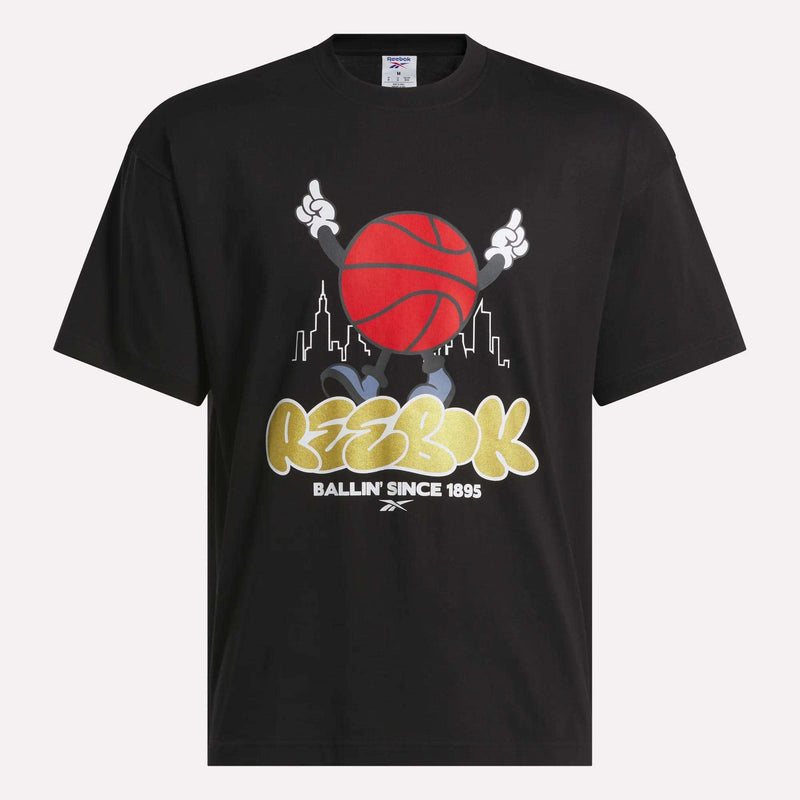 Reebok Men's Basketball T-Shirt—black cotton tee with a cartoon character holding a red basketball, city skyline background, and bold "Reebok Ballin Since 1895" text. Perfect for basketball fans.
