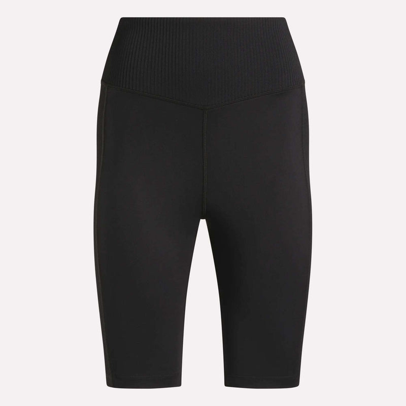 Reebok Women's Peached Biker Shorts 9" in black, featuring a high-rise ribbed waistband, seamless front, mid-thigh length, and soft peached fabric, shown on a plain light background.