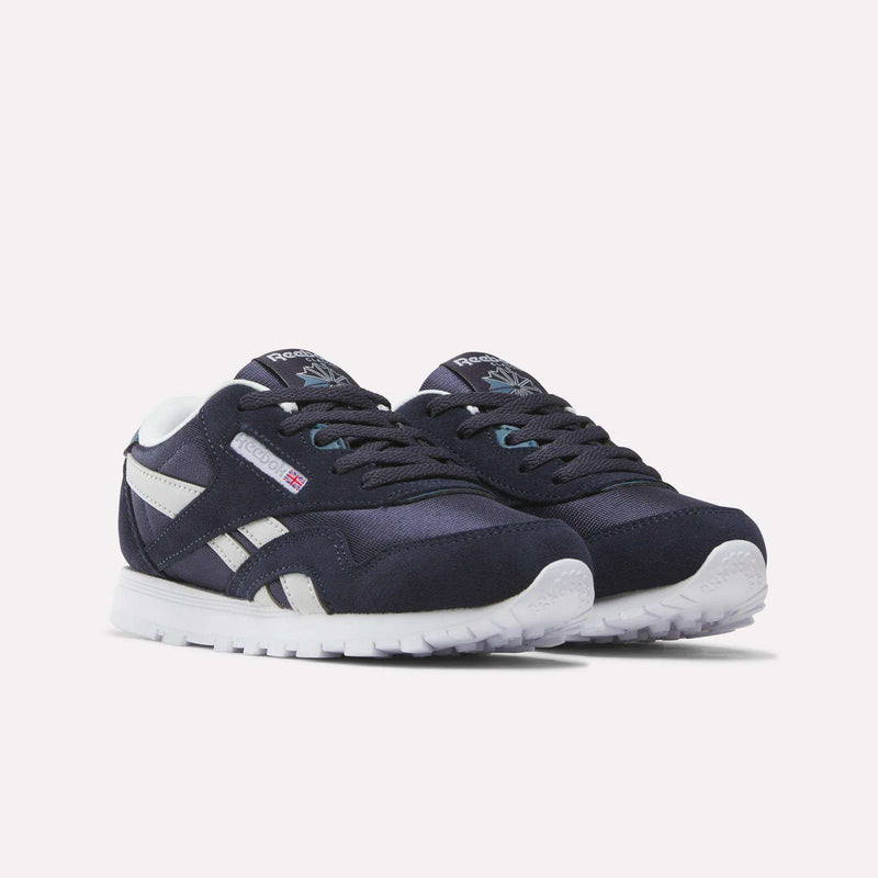 A pair of Reebok Classic Nylon Shoes - Little Kids in navy blue with white accents and white soles, shown against a light background—ideal as stylish boys’ footwear for any casual occasion.