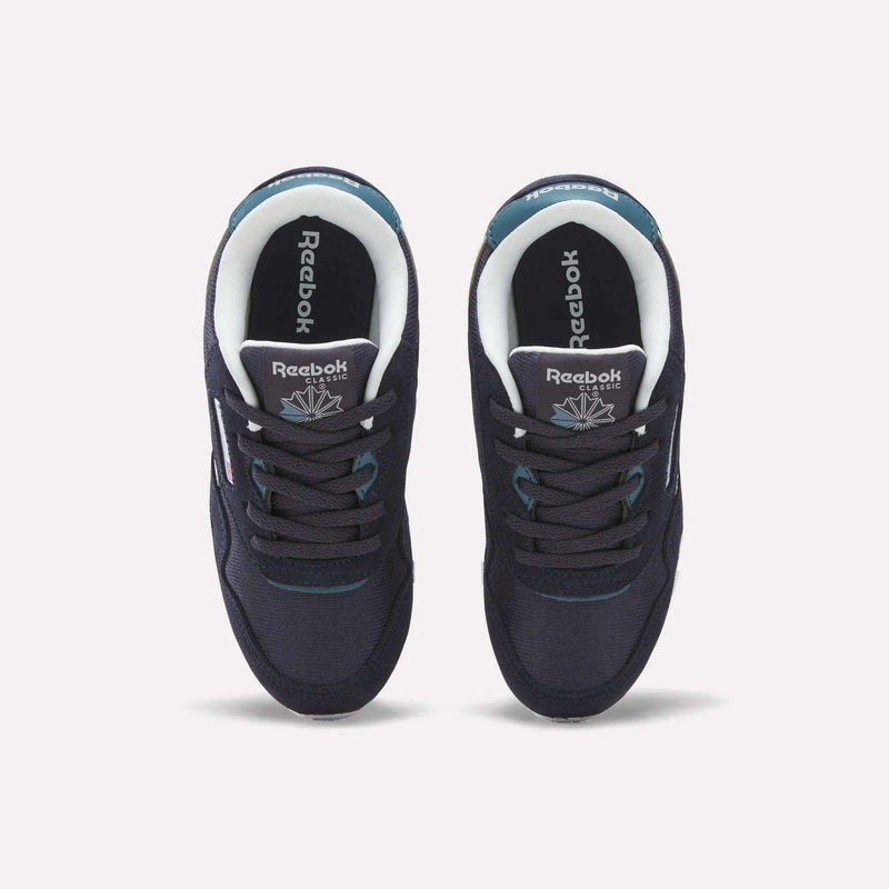 A pair of Reebok Classic Nylon Shoes - Little Kids in navy blue, featuring black laces and white Reebok logos on the tongues and insoles, viewed from above on a plain light background—ideal for boys’ shoe collections.