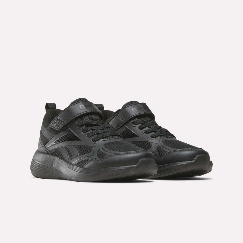 The Reebok Rush Runner 6.0 Elastic Lace Top Strap Running Shoes for little kids feature a black design with Velcro and laces, a textured sole, and subtle details—perfect for all-day play, shown against a plain light background.