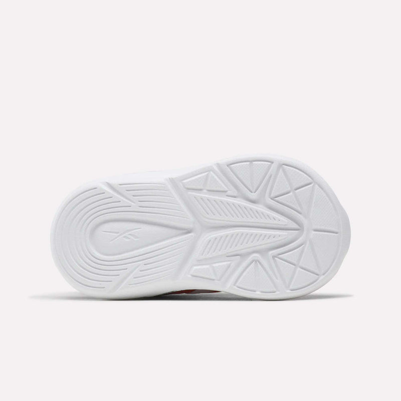 The image features the white sole of Reebok Rush Runner 6.0 Gore Lace Top Strap Running Shoes for babies and toddlers, with a geometric tread pattern, subtle center branding, and lightweight EVA cushioning, shown against a plain light background.