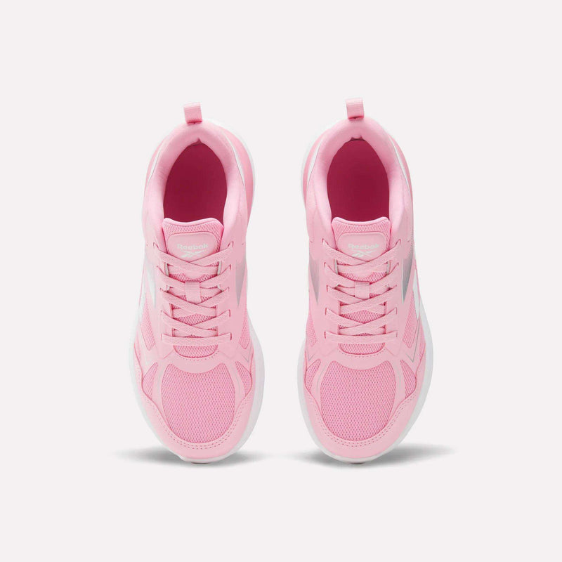 Top view of a pair of light pink Reebok Rush Runner 6.0 Running Shoes for big kids, featuring white EVA midsoles and laces, arranged side by side on a plain white background.