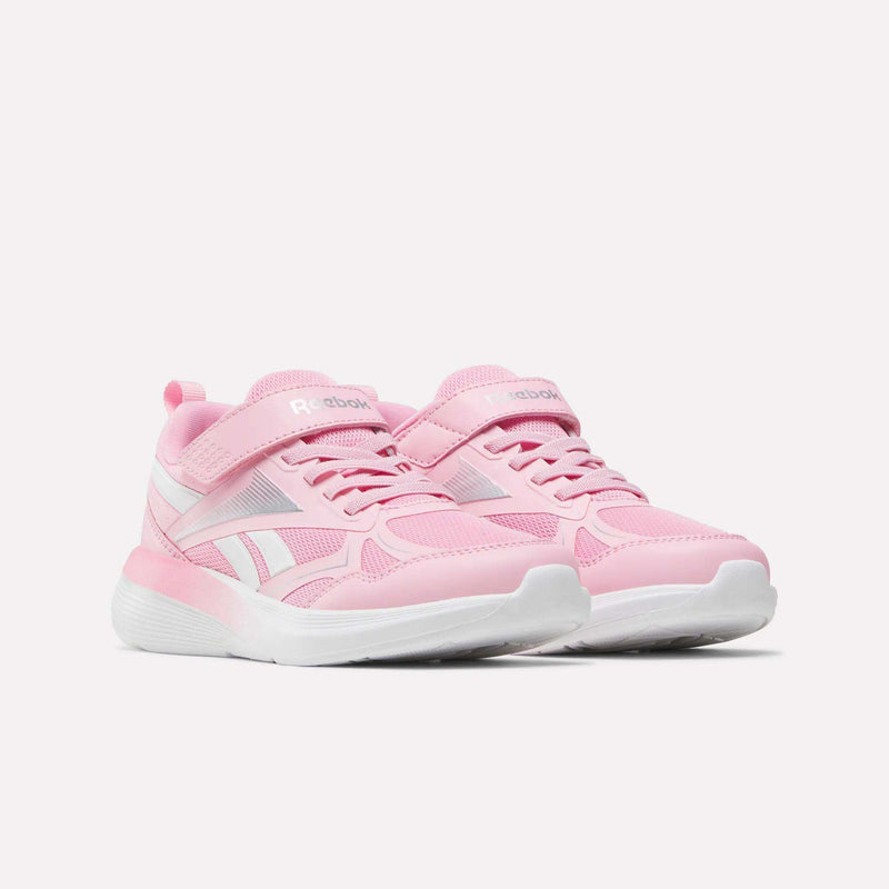 The Reebok Rush Runner 6.0 Elastic Lace Top Strap Running Shoes for little kids in pink and white feature velcro straps and laces, making them perfect running shoes for girls, shown on a white background.