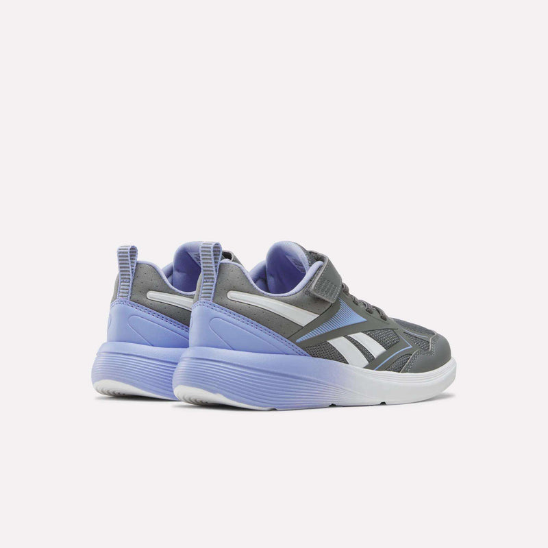 A pair of Reebok Rush Runner 6.0 Elastic Lace Top Strap Running Shoes for little kids, featuring a gray and lavender colorway with white soles, designed for all-day comfort, shown from the back and slightly to the side on a plain white background.