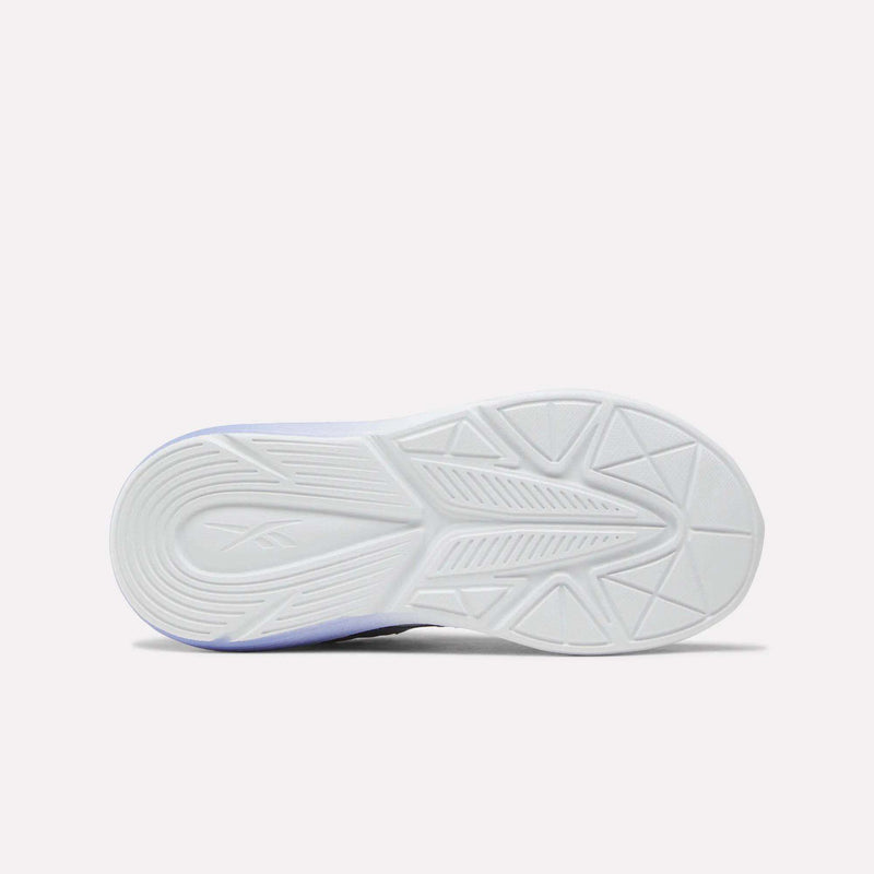 The image displays the white sole of the Reebok Rush Runner 6.0 Elastic Lace Top Strap Running Shoes for little kids, featuring a textured geometric pattern and a subtle brand logo imprint, viewed from below against a plain light background—emphasizing all-day comfort tailored for active feet.