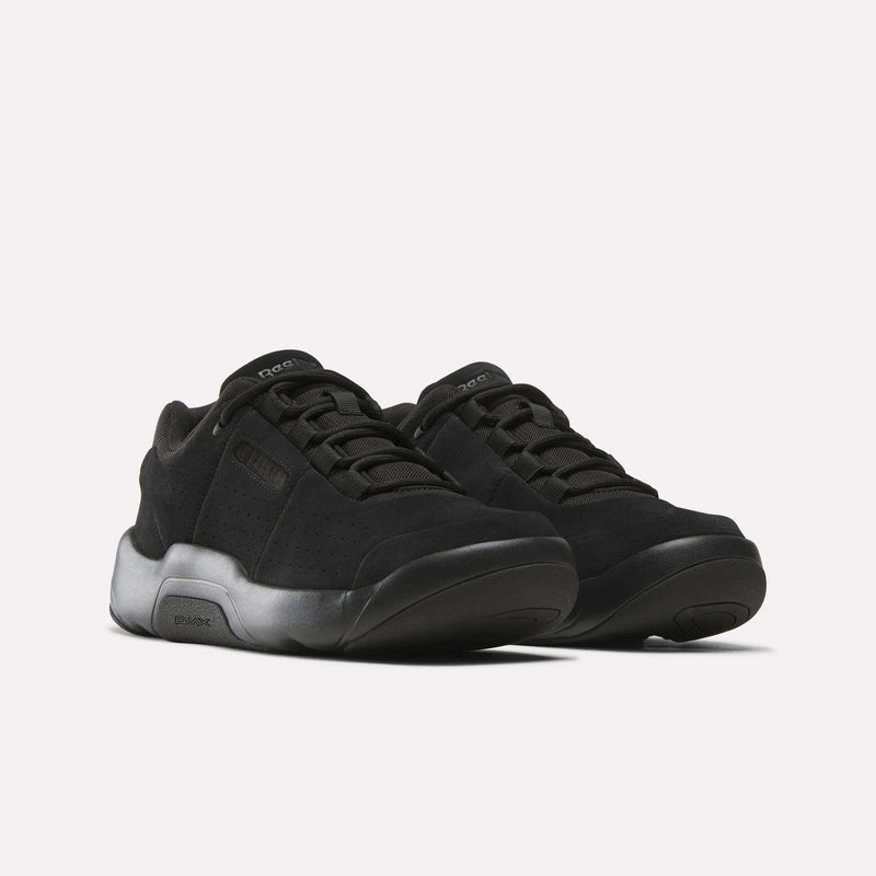A pair of Reebok DMX Comfort+ Classic sneakers with thick, gradient black-to-gray soles and dynamic air cushioning are displayed side by side on a plain white background.