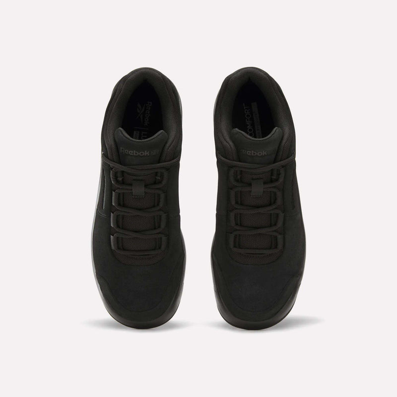 A pair of Reebok DMX Comfort+ Classic sneakers in black premium leather are viewed from above, displaying their laces and tongue against a plain white background.