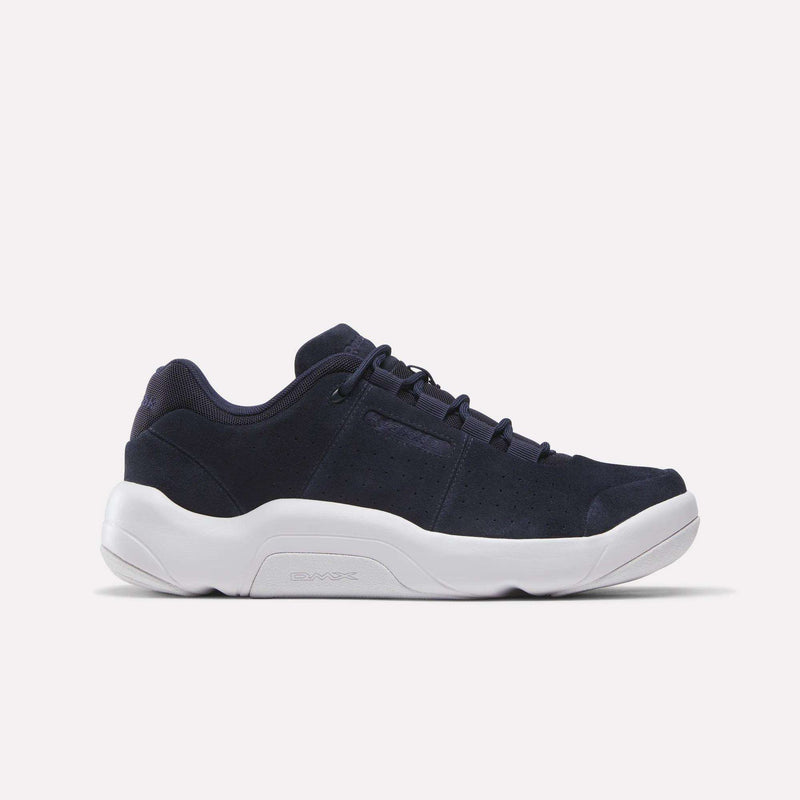 The Reebok DMX Comfort+ Classic, shown in Vector Navy with a low-top silhouette, is crafted from premium leather and features black laces and a thick white sole with dynamic air cushioning. The shoe is displayed against a plain white background.