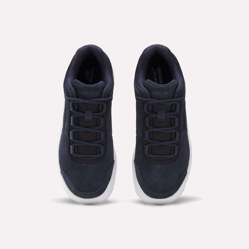 A pair of Reebok DMX Comfort+ Classic black athletic walking shoes with premium leather accents and white soles, viewed from above and placed side by side on a plain white background.