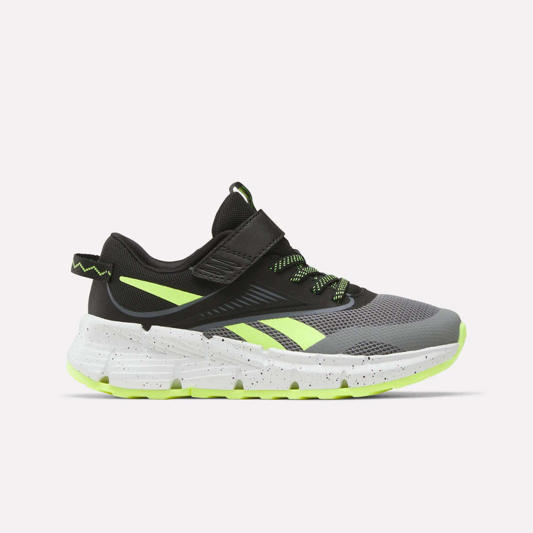 The Reebok Zig Dynamica 6 Running Shoes for little kids, in Grey 4/Black/Digital Lime, feature a mesh upper, neon accents, Zig technology in the white speckled sole, and a hook-and-loop strap. Shown from the side on a plain white background.