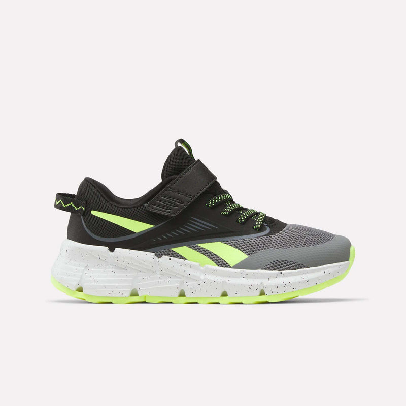 The Reebok Zig Dynamica 6 Running Shoes for little kids, in Grey 4/Black/Digital Lime, feature a mesh upper, neon accents, Zig technology in the white speckled sole, and a hook-and-loop strap. Shown from the side on a plain white background.