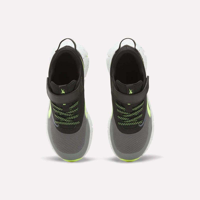 Top view of Reebok Zig Dynamica 6 Running Shoes for little kids in black and gray with neon green accents, white Zig soles, mesh uppers, black pull tabs, and green/black laces on a white background.