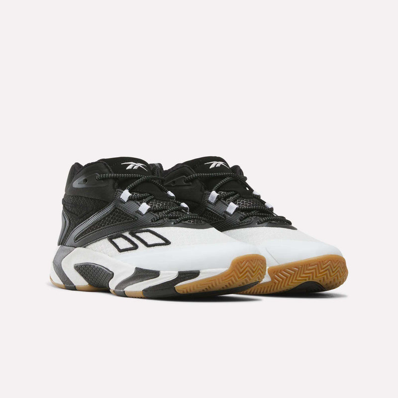 A pair of Reebok Zone Breaker Shoes for big kids in black, white, and gray. These boys’ basketball sneakers feature mesh and synthetic panels, angular detailing, white midsoles with bold black patterns for extra style, ankle support, and gum rubber soles.