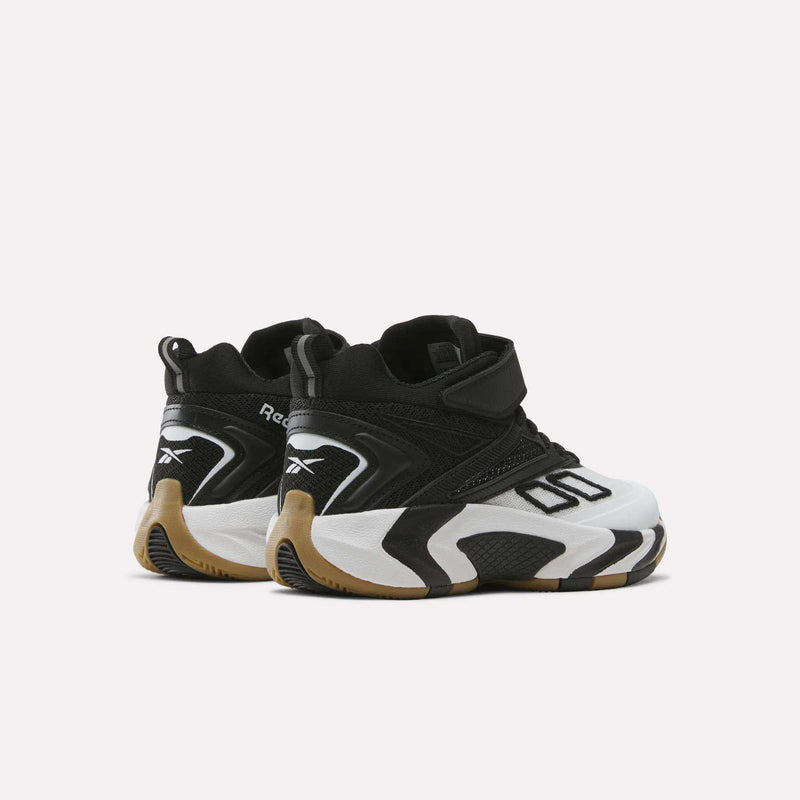 Zone Breaker Shoes for little kids by Reebok, shown in black and white with a chunky sole and gum accents. These mid-cut sneakers are displayed from the back and side against a plain white background.