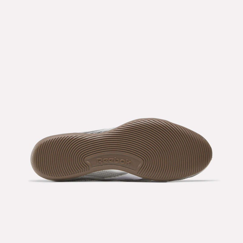 A brown rubber sole of the Women’s Ultra Lo Mary Jane Shoes by Reebok, featuring circular tread patterns and the Reebok logo embossed at the center. Ideal for those looking for low-profile footwear, this design stands out against a plain white background.