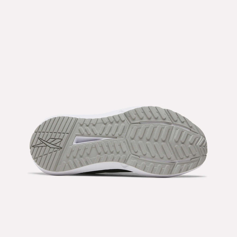 The image displays the gray rubber outsole of Reebok Women's Cityride 2 Running Shoes, featuring a textured tread with zigzag and straight grooves for traction. A Reebok logo appears on the left side. The background is plain white.