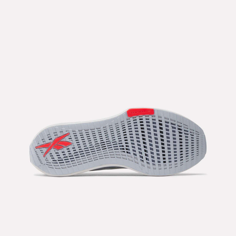 The image shows the sole of the Men's FloatZig Tread Running Shoes by Reebok in light gray, featuring a grid-like tread pattern, a red Reebok logo near the heel, and a red accent at the toe—perfect for treadmill workouts.
