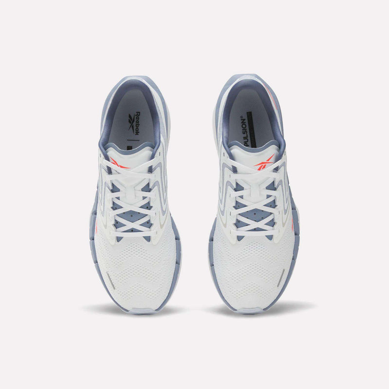 A pair of Reebok Men's FloatZig Tread Running Shoes in white with light blue accents viewed from above, highlighting the laces, mesh upper, and Reebok logo—perfect for treadmill workouts.