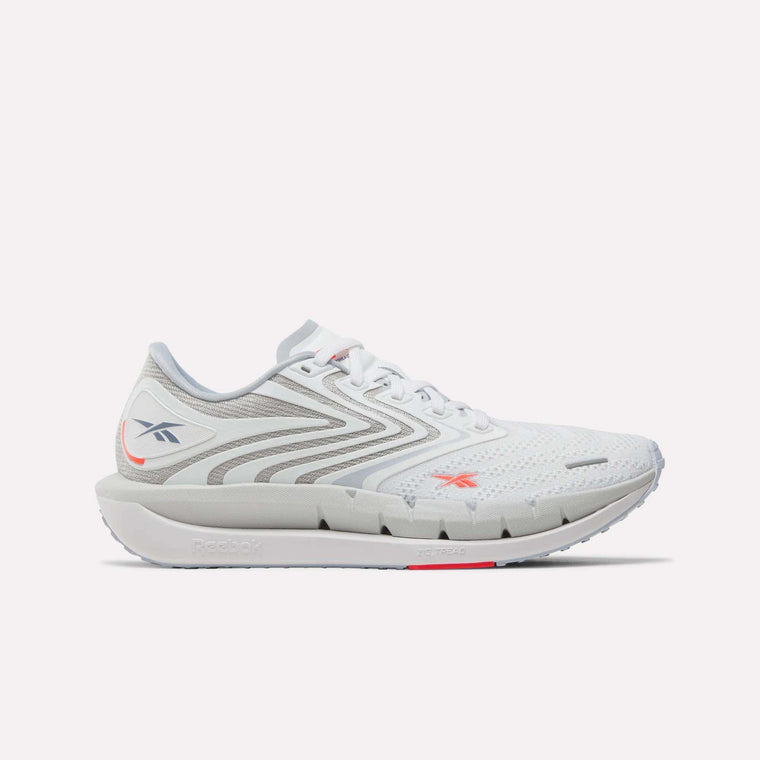 Reebok Women's FloatZig Tread Running Shoes in Ftwr White/Tranquil Blue/Neon Cherry feature a breathable mesh upper, lace-up design, logo detail, and cushioned sole—ideal for treadmill workouts.