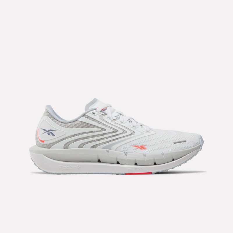 Reebok Women's FloatZig Tread Running Shoes in Ftwr White/Tranquil Blue/Neon Cherry feature a breathable mesh upper, lace-up design, logo detail, and cushioned sole—ideal for treadmill workouts.